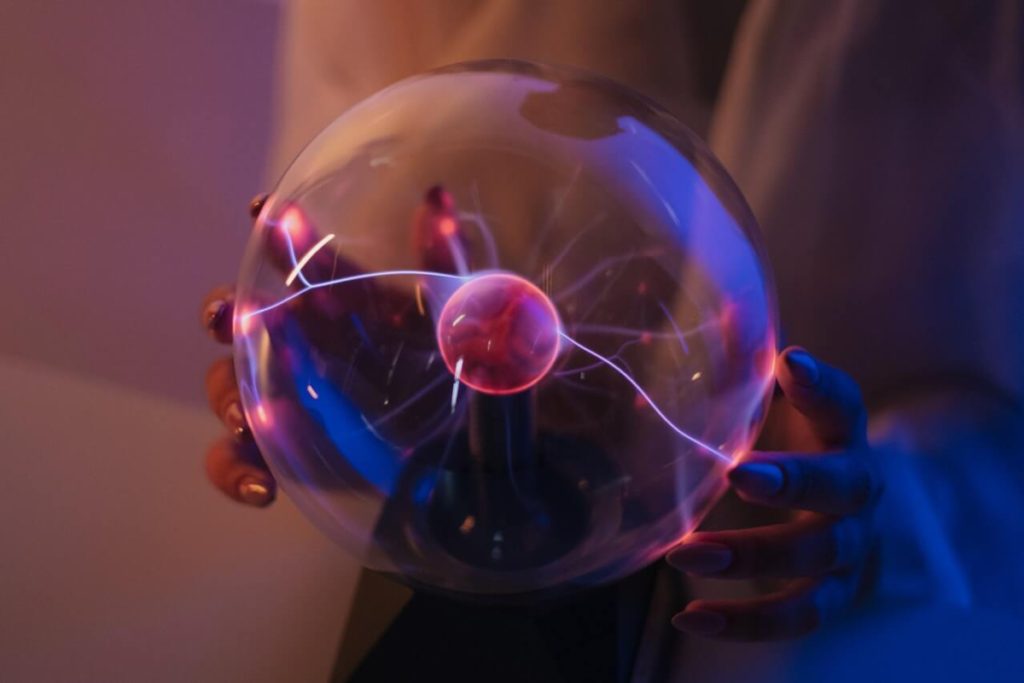 woman holding plasma globe - women's history month cyber security resources for women