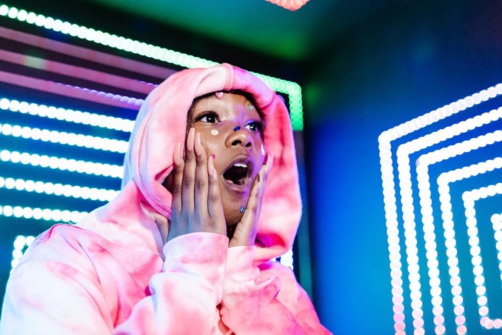 woman in pink hoodie looking shocked_cybersecurity awareness month_cyber security resources for women